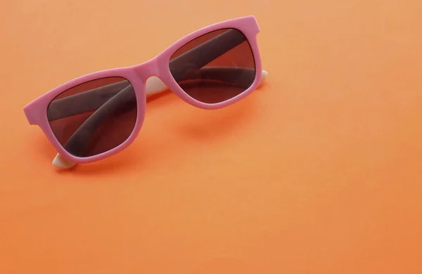 stock image sunglasses round in pink plastic frame isolated on a white background.retro fashion bold frame style