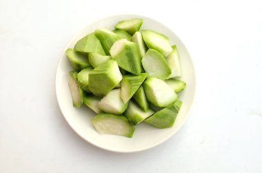 Dilimlenmiş taze yeşil Tırmanan Gıdaklama (Acacia Pennata) beyaz bir plaka içinde izole edilmiş, yiyecek hazırlayın.