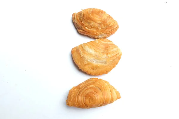 deep fried curry puff,curry puff pastry, karipap,epok epok, spiral curry puff isolated a white backdrop  . thai curry puff concept.this pastry is asian traditional snacks