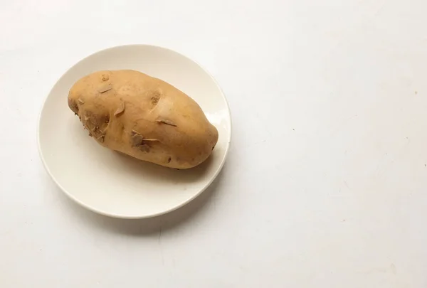 heaps of fresh raw baby potato (Solanum tuberosum) head or Young potato isolate on a white background
