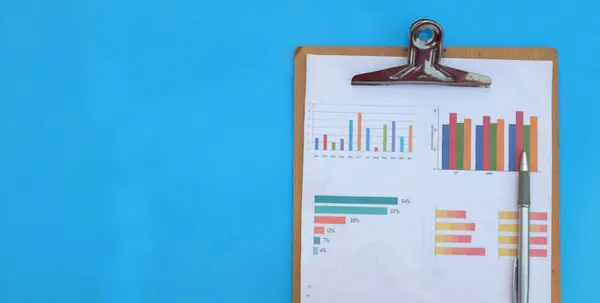 Report paper document Business report chart preparing graphs white pen on blue office desk