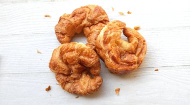 Kahvaltı için Fransız kruvasanı taze pişmiş kruvasan beyaz ahşap masa üzerinde, fotokopi alanı olan üst manzara. Lezzetli bir kahvaltı, lezzetli ve sağlıklı bir başlangıç..