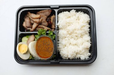 Kızarmış domuz eti, haşlanmış yumurta ve tatlı sosla kaplanmış tatlı. Beyaz bir arka planda izole edilmiş. Tayland yemeği. Kutu sette kızartılmış biftek.