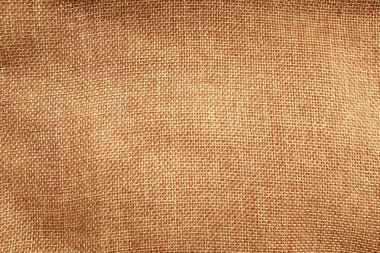 Üst ve düz bir çuval bezi çuval bezi çuvalı ya da desenli çuval bezi çuval bezi dokusu, arkaplan ve boş alan için açık doğal keten dokusu tasarlama veya reklam ağları için yatar.
