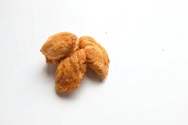 Image of curry puff ,Curry puff pastry, locally known as karipap isolate on a white backdrop.Asian traditional snacks that has crispy shell. Thai crispy curry puff concept.