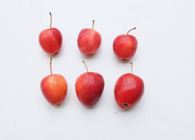 Taze organik olgun kırmızı cüce elma, prenses elması, mini elma, küçük elma, kiraz elması, beyaz arka planda izole edilmiş parlak kırmızı elmalar. Sağlıklı meyve kavramı.