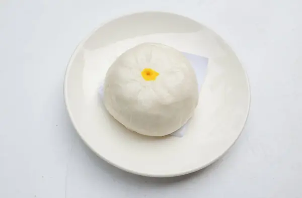 Delicious stuffed steamed bun or chinese bun ,Chinese food steamed roll,  chinese dim sum Arrange on  serving plate isolate on a white backdrop .Chinese food style,eating in the morning
