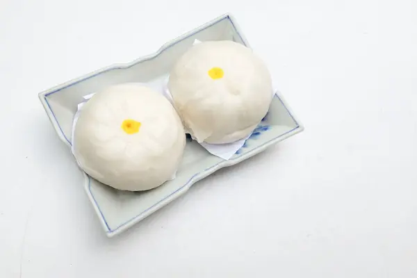 Delicious stuffed steamed bun or chinese bun ,Chinese food steamed roll,  chinese dim sum Arrange on  serving plate isolate on a white backdrop .Chinese food style,eating in the morning