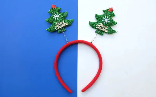 decorated Beautiful headband funny christmas trees isolate on a blue and white backdrop.concept of joyful Christmas party,New year is comindecorated Beautiful headband funny red star g soon, festive season decoration with Christmas elements