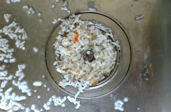 Waste rice, food waste, garbage, leftover food clogged filter, clogged or metal drain strainer, in the sink, food waste, waste from after washing dishes