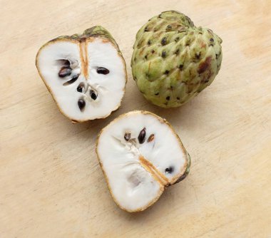 Taze yeşil kremalı elma, elma şekeri, anona cherimola (annona squamosa l.) meyve dilimlenmiş, ahşap masa zemininde. Tropikal egzotik meyve ve sağlıklı meyve