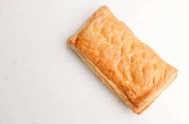 Image of Appetizing closely packed fresh square shaped puff pastry biscuit snacks with puffed crispy golden brown crust layersa  isolate on a white backdrop. Traditional Asian dessert or breakfast