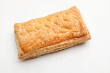 Image of Appetizing closely packed fresh square shaped puff pastry biscuit snacks with puffed crispy golden brown crust layersa  isolate on a white backdrop. Traditional Asian dessert or breakfast