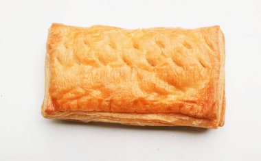 Image of Appetizing closely packed fresh square shaped puff pastry biscuit snacks with puffed crispy golden brown crust layersa  isolate on a white backdrop. Traditional Asian dessert or breakfast