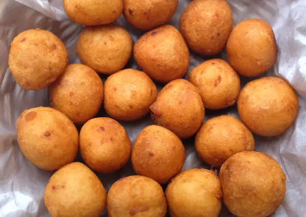 stock image close up a Thai Deep Fried  Sweet Potato Balls or (Khanom khai nok kratha) in a white ceramic dish isolate on a white backdrop.is a Thai snack. The sweet is a fried sweet potato dough ball