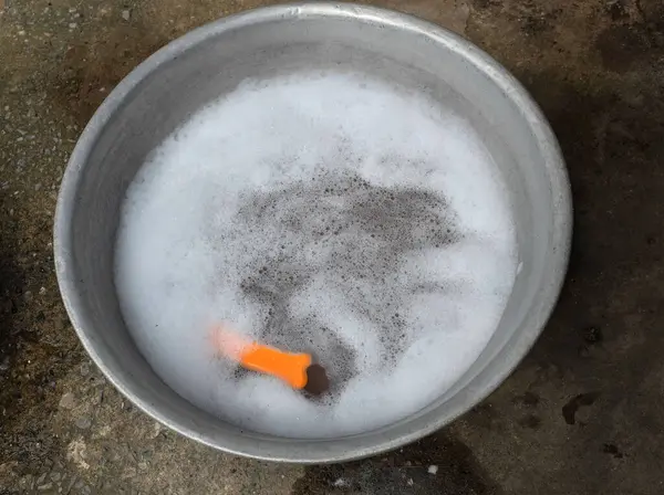 stock image Top view of detergent foam bubble and laundry brush in  basin  for clothes washing.Laundry concept