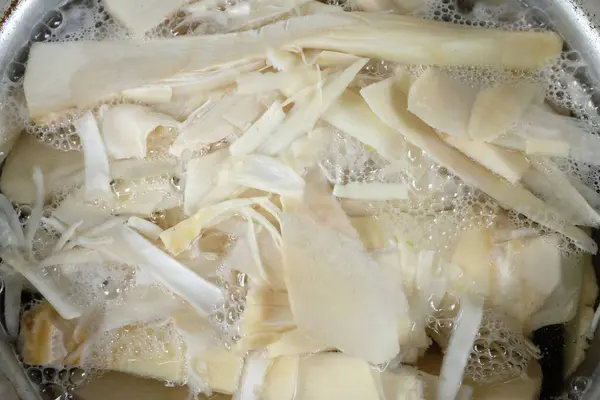 stock image Pile fresh Sliced Bamboo shoot, Bamboo sprout (Bambusa spp) in Boiling in the pot.Edible bamboo that breaks from underground rhizomes.Vegetables and healthy f