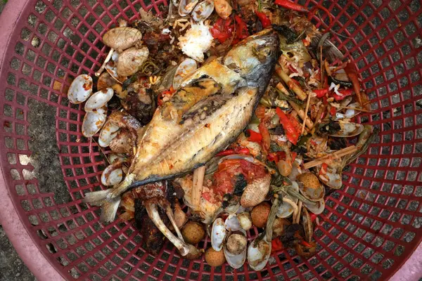 stock image fishbone,Bones or Scrap of food in the plastic basket after eating. Remains of fried fish. food scraps.