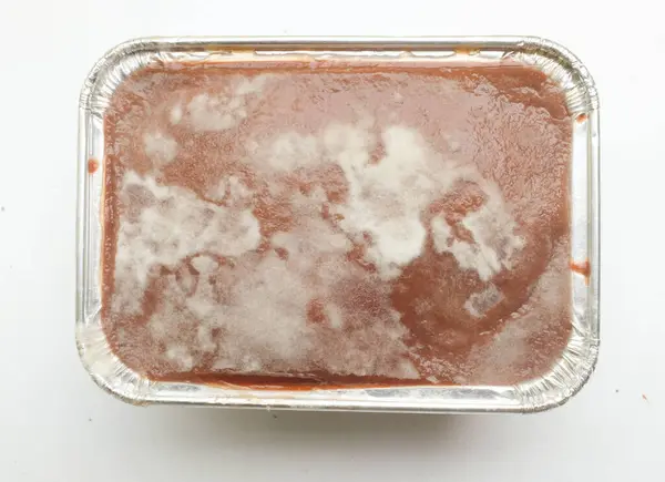 stock image moldy sweet chocolate bread or Moldy mold on chocolate pudding close up in a plastic container.Unhealthy food,on chocolate cake with moldy.