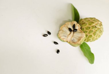 flat lay composition with fresh ripe custard apple,sugar apple, annona cherimola (annona squamosa l.) fruit cut in half sliced with leaves isolated on white backdrop. tropical exotic fruit clipart