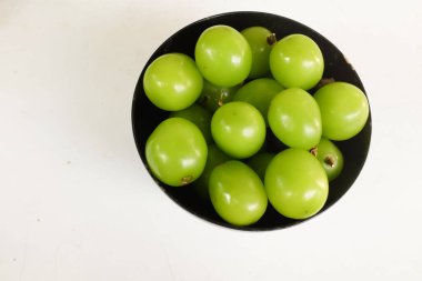 Bir kase yeşil üzüme izole edilmiş taze, tatlı yeşil Muscat (Vitis vinifera) üzümü. Japon üzümleri. Üzüm yeşili. Tadı tatlı ve doğal..