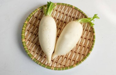 fresh white daikon, daikon radish, radish, white radish,(raphanus sativus var. longipinnatus) On a wooden tray isolated on a white  background.flat lay clipart