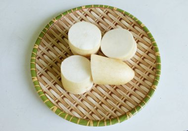 Sliced fresh white daikon, daikon radish, radish, white radish,(raphanus sativus var. longipinnatus)  isolated On a wooden tray.Preparing vegetables for healthy cooking clipart