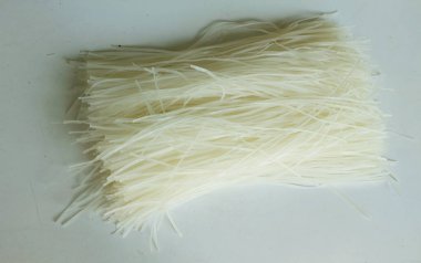 Üst ve düz bir zemin, kurutulmamış pirinç eriştesi, kurutulmuş çiğ pirinç eriştesi, beyaz zemin üzerinde izole edilmiş Tayland kurutulmuş pirinç eriştesi.