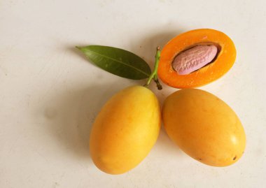 Üst ve düz taze tatlı olgun Marian eriği yığını Tayland meyvesi beyaz bir zemin üzerinde izole (mayongchid maprang marian erik ve erik mango, thailand). Tayland 'ın sağlıklı meyveleri