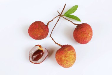 Yığınla taze taze, sulu kırmızı liçi, litçi, liçi meyveleri (litchi chinensis sonn). Tüm liçi ve ikiye bölünmüş yeşil yaprak beyaz bir zemin üzerinde izole edilmiş.