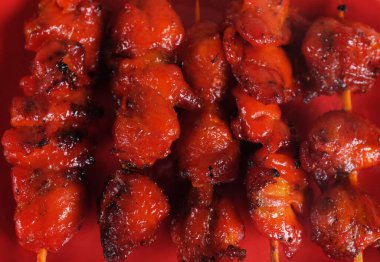 appetizing a chicken butt grilled ,chicken grilled skewered on bamboo isolate on a white backdrop . halal food, street food in thailand