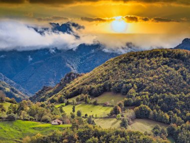 Cabin, woods and mountains in autumn, Aller, Asturias, Spain clipart