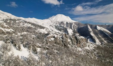 Snowy landscape at Redes Natural Park, Tiatordos Peak, 1951 meters in backgorund, Asturias, Spain clipart