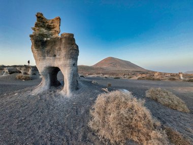 Los Roferos de Teseguite geological formations and Montana de Guenia in the background, Teguise municipality, Lanzarote island, Spain, Europe clipart