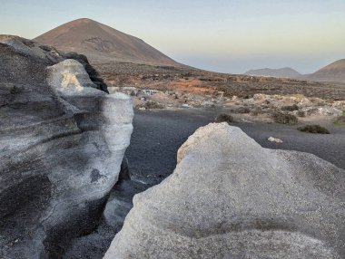 Los Roferos de Teseguite geological formations and Montana de Guenia in the background, Teguise municipality, Lanzarote island, Spain, Europe clipart