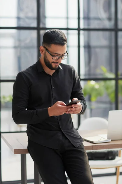 stock image Young casual Businessman holding and using smartphone for sms messages