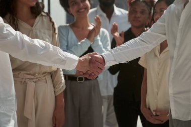 Business people shaking hands, finishing up a meeting clipart