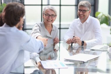 discussion of business people in the office sitting at the table