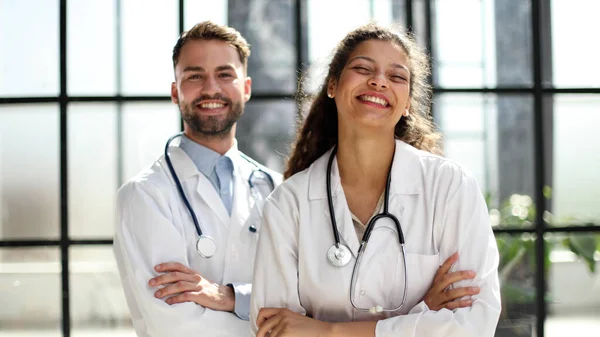 female doctor and male doctor stand in the lobby of the hospital