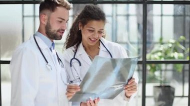 male doctor and female doctors with x-ray results. Professional consulting. Patient test results. Young professionals. group of clinicians.