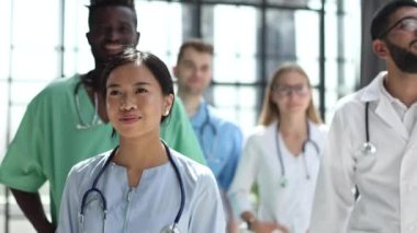 a group of different doctors are standing in the corridor of the hospital
