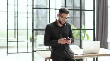 Businessman talking with mobile phone in the office