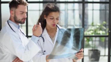 male doctor and female doctors with x-ray results. Professional consulting. Patient test results. Young professionals. group of clinicians.