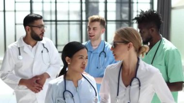 multinational medical team stands together in a building