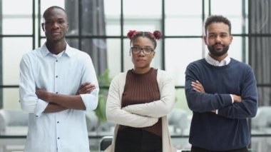 Successful african american business team standing with arms crossed in the office