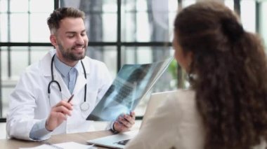 Doctor observing x-ray, patient waiting for diagnosis
