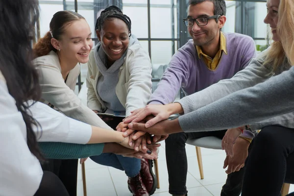 stock image close-up of a business team sitting holding hands