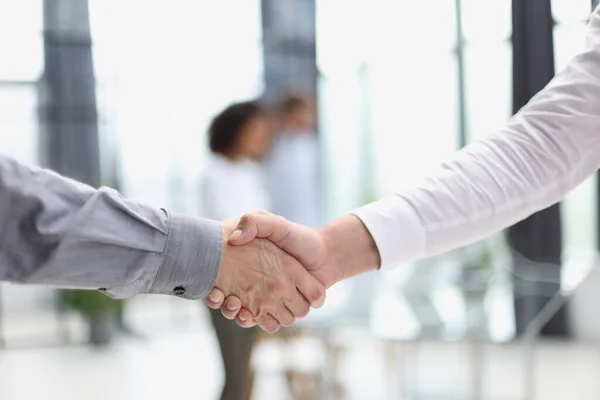 stock image Close up people shaking hands on blurred background