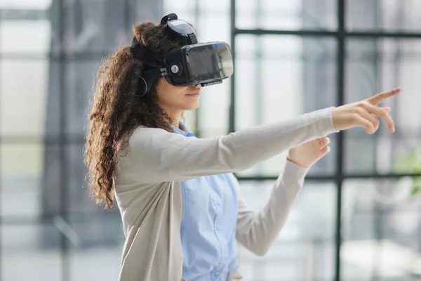 Stock image Girl trying to touch objects in virtual reality.