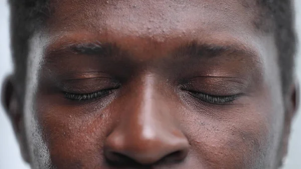 Close-up of a black mans closed eyes. Eyes of a thoughtful person
